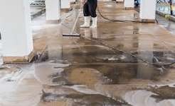 Antimicrobial floor scrubbing and water extraction near damaged cabinetry and woodwork